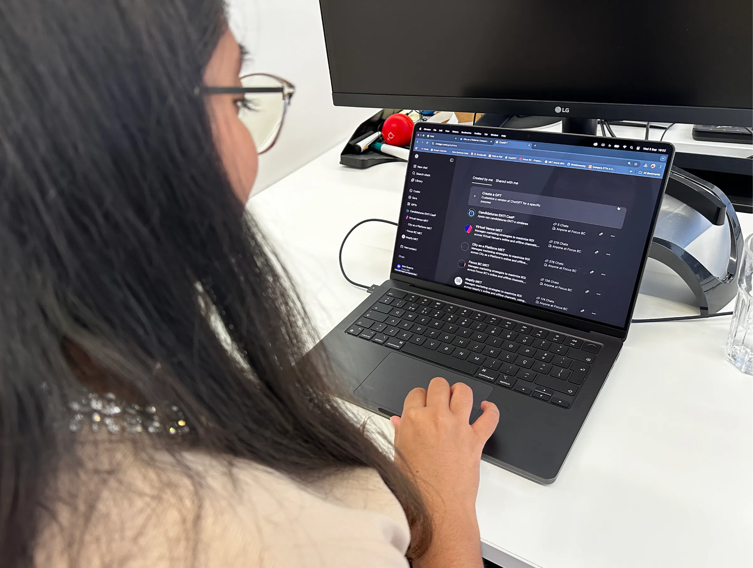Focus BC marketing team member using custom ChatGPTs on a laptop at the office, showcasing AI-powered tools to boost productivity and streamline workflows.