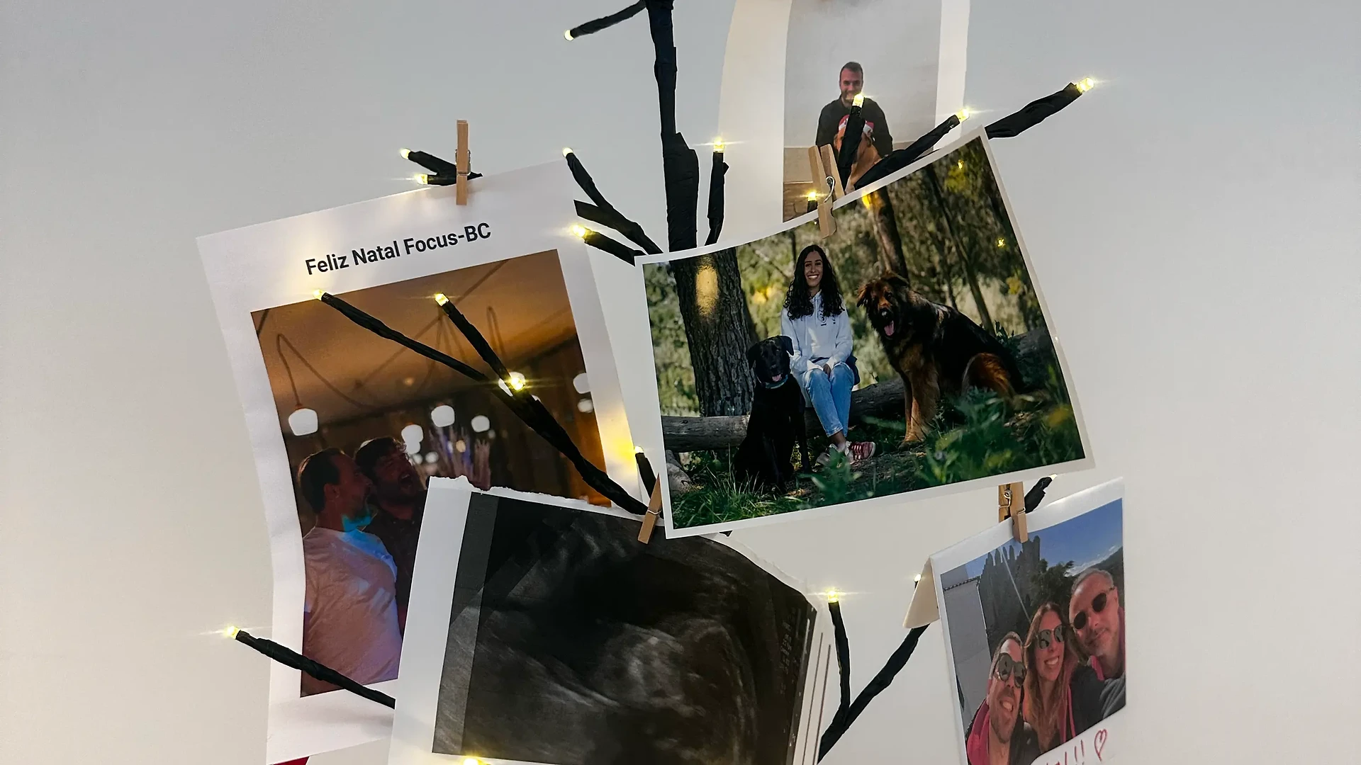 Founders in Santa hats and festive glasses laughing and embracing for a holiday photo indoors.