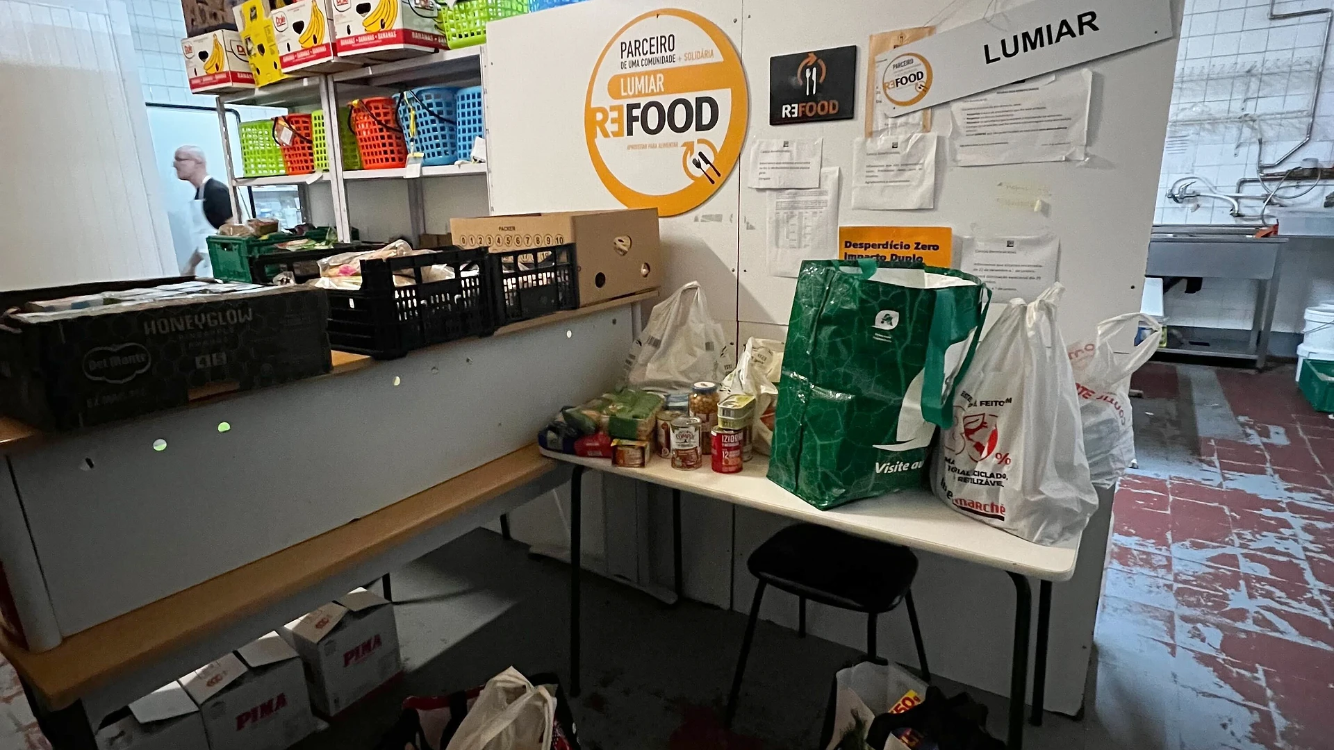 Close-up of the lit Christmas tree branches with personal photos attached as festive decorations.