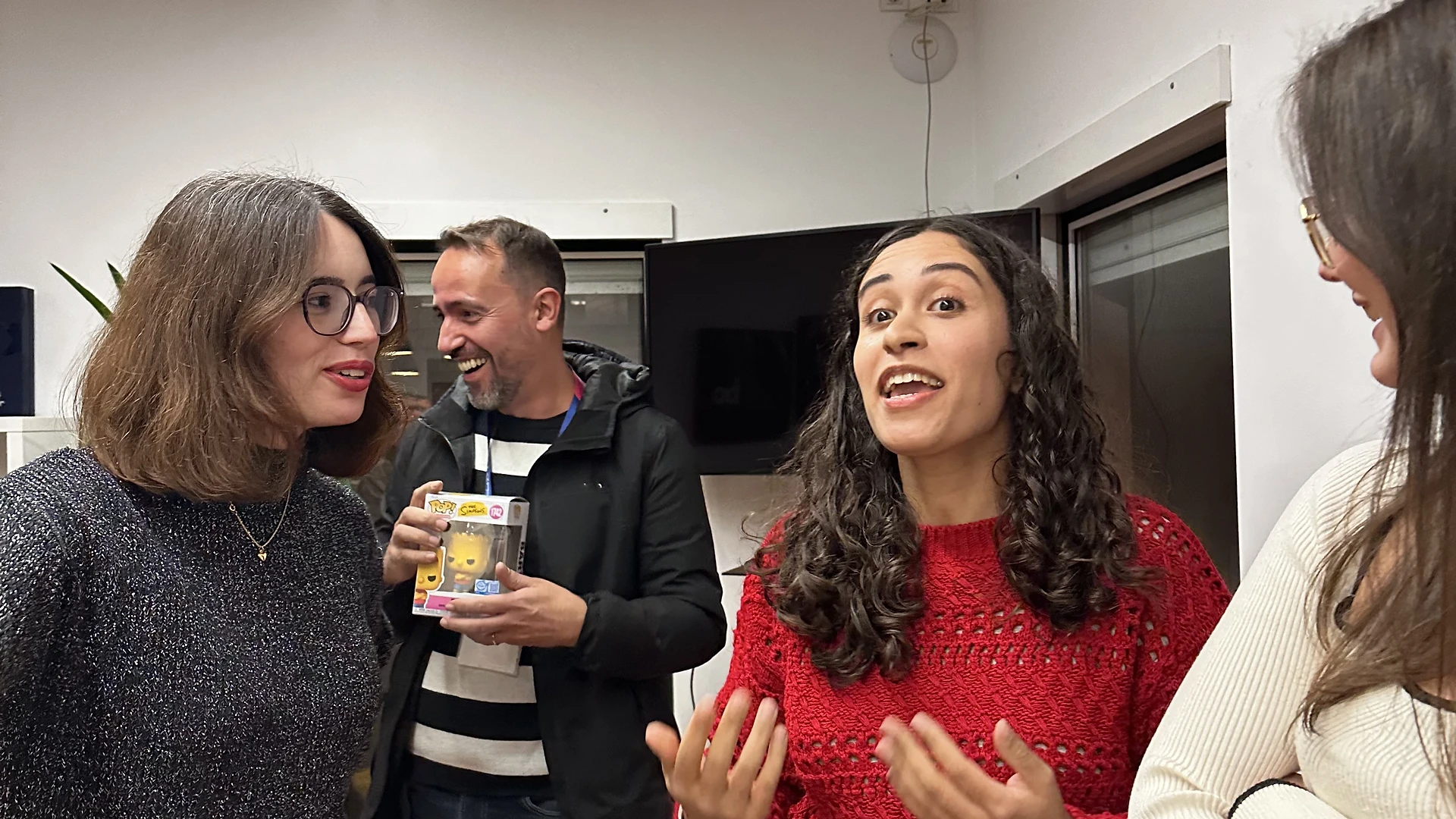 The illuminated Christmas tree decorated with team photos and handwritten holiday notes.