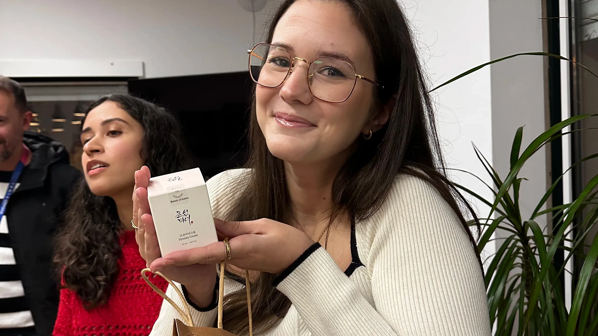 Close-up of printed photos hanging from the tree, with handwritten Christmas wishes visible below them.