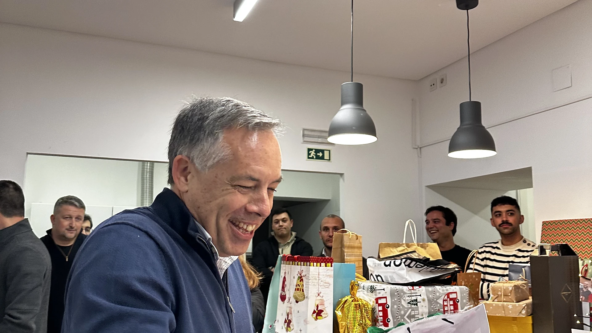 A printed pic attached to the tree featuring photos and a handwritten message wishing a Merry Christmas and Happy New Year.