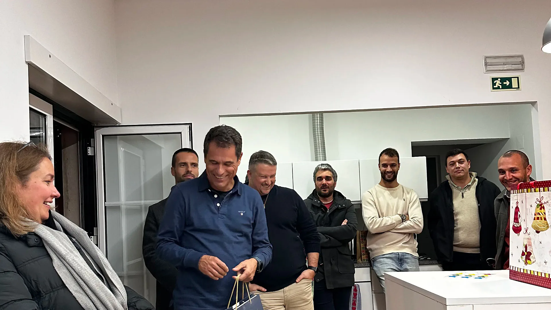 A printed pic attached to the tree featuring photos and a handwritten message wishing a Merry Christmas and Happy New Year.