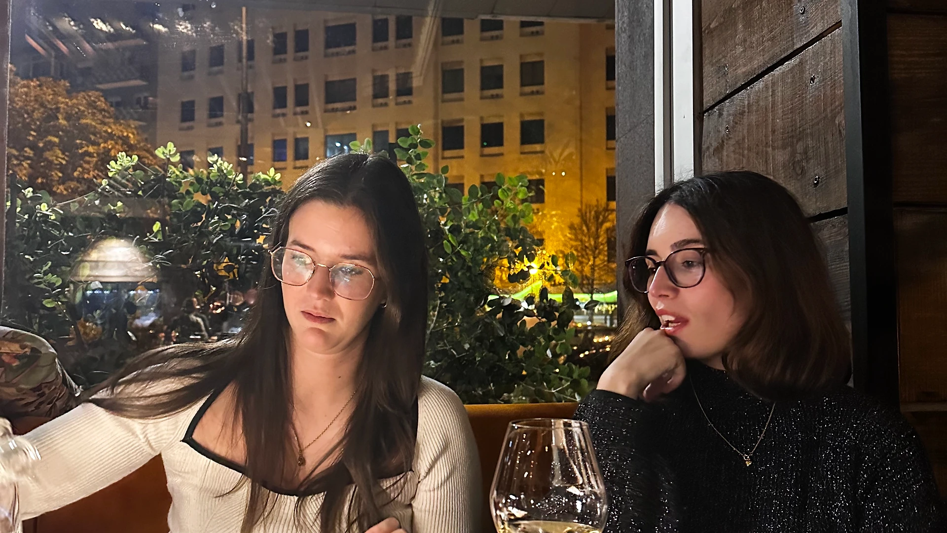 Colleagues gathered around a table filled with wrapped gifts during an office Secret Santa exchange.