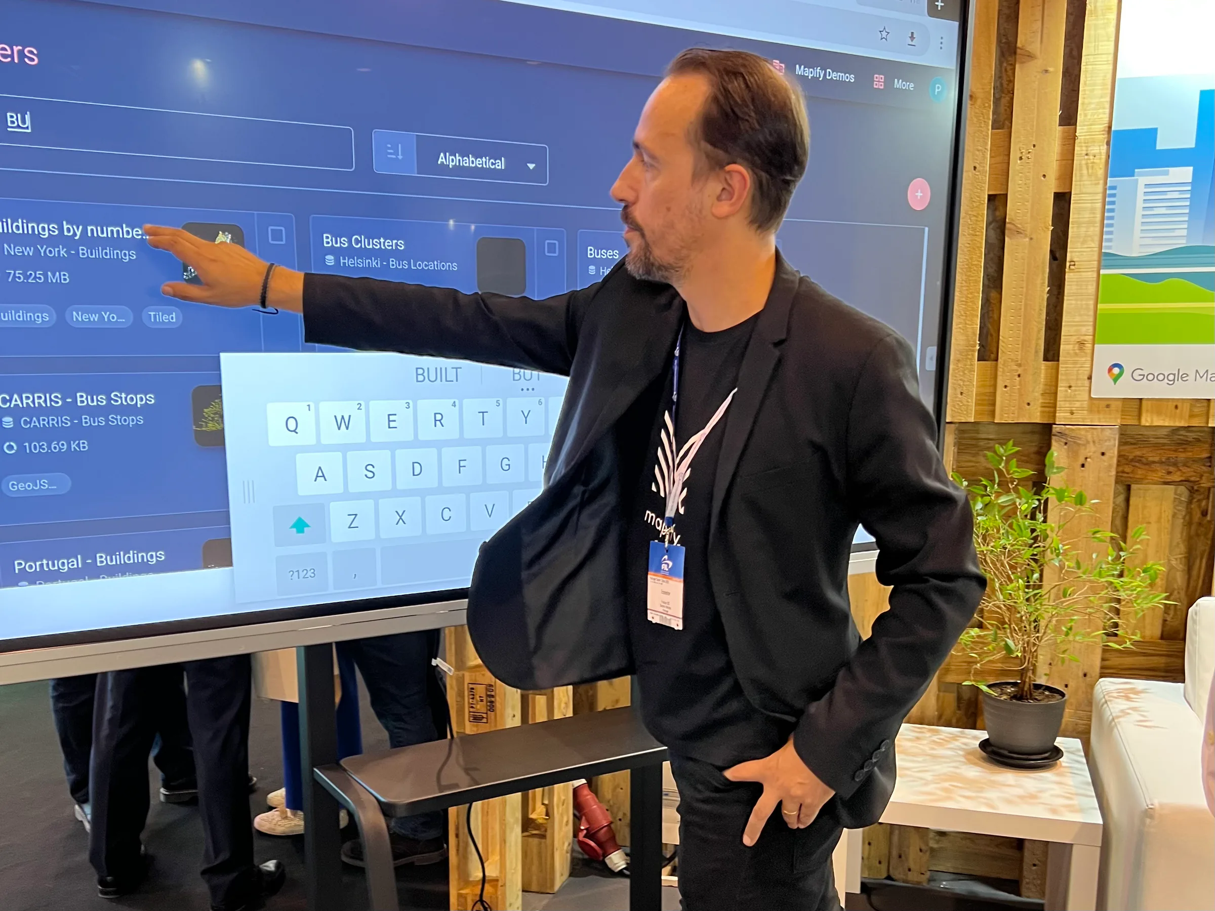 Exhibition stand showcasing a smart city command and control center with multiple data dashboards displayed on large screens and laptops.