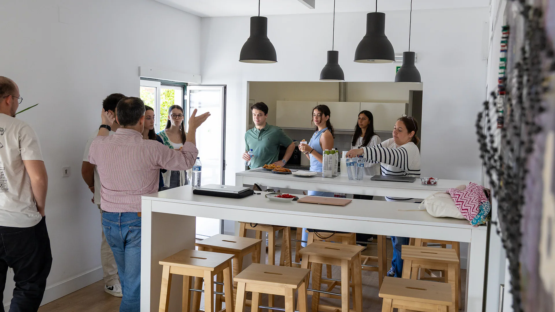 Over-the-shoulder view of a participant’s laptop screen displaying the Mapify website, with the tagline “Mapify for Education is our commitment to the future of geospatial analysis.” The colorful beanbags from earlier are visible in the background.