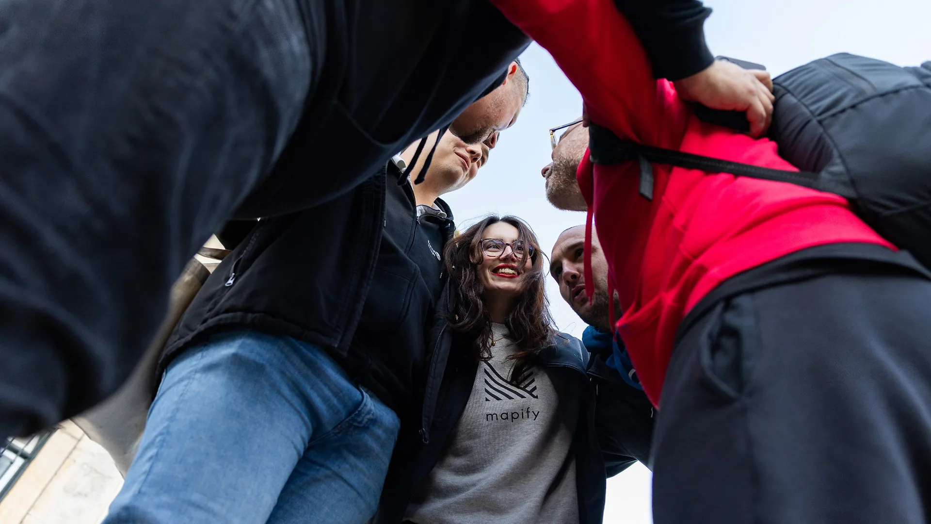 Two men singing together into a microphone, laughing and enjoying the karaoke performance in a restaurant setting.
