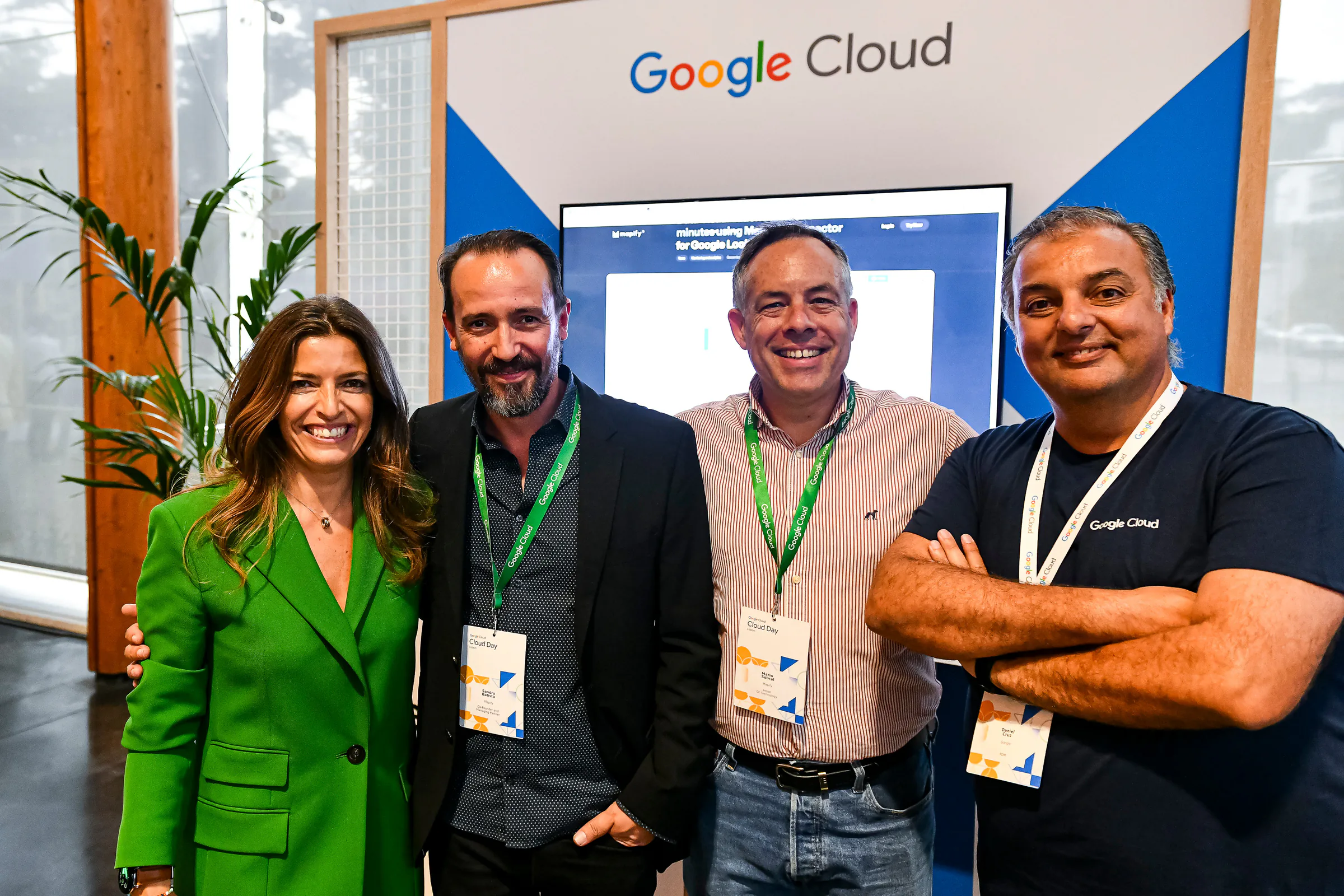 From left to right, Sofia Marta, Sandro Batista, Mário Sobral, and Daniel Cruz stand together at the Mapify booth during Google Cloud Day Lisbon 2024, held at the Centro de Congressos do Estoril. The booth features a Google Cloud banner in the background, and a screen showcasing the product page (Mapify). They are all wearing Google Cloud lanyards, and Daniel is wearing a Google Cloud T-shirt.